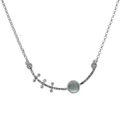 Silver necklace with small round pendants on a white background