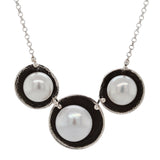 Necklace with three pearls in black circles on a white background